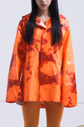 ORANGE RAINCOAT INTERVENED WITH SPRAY PAINT X ALDO CHAPARRO