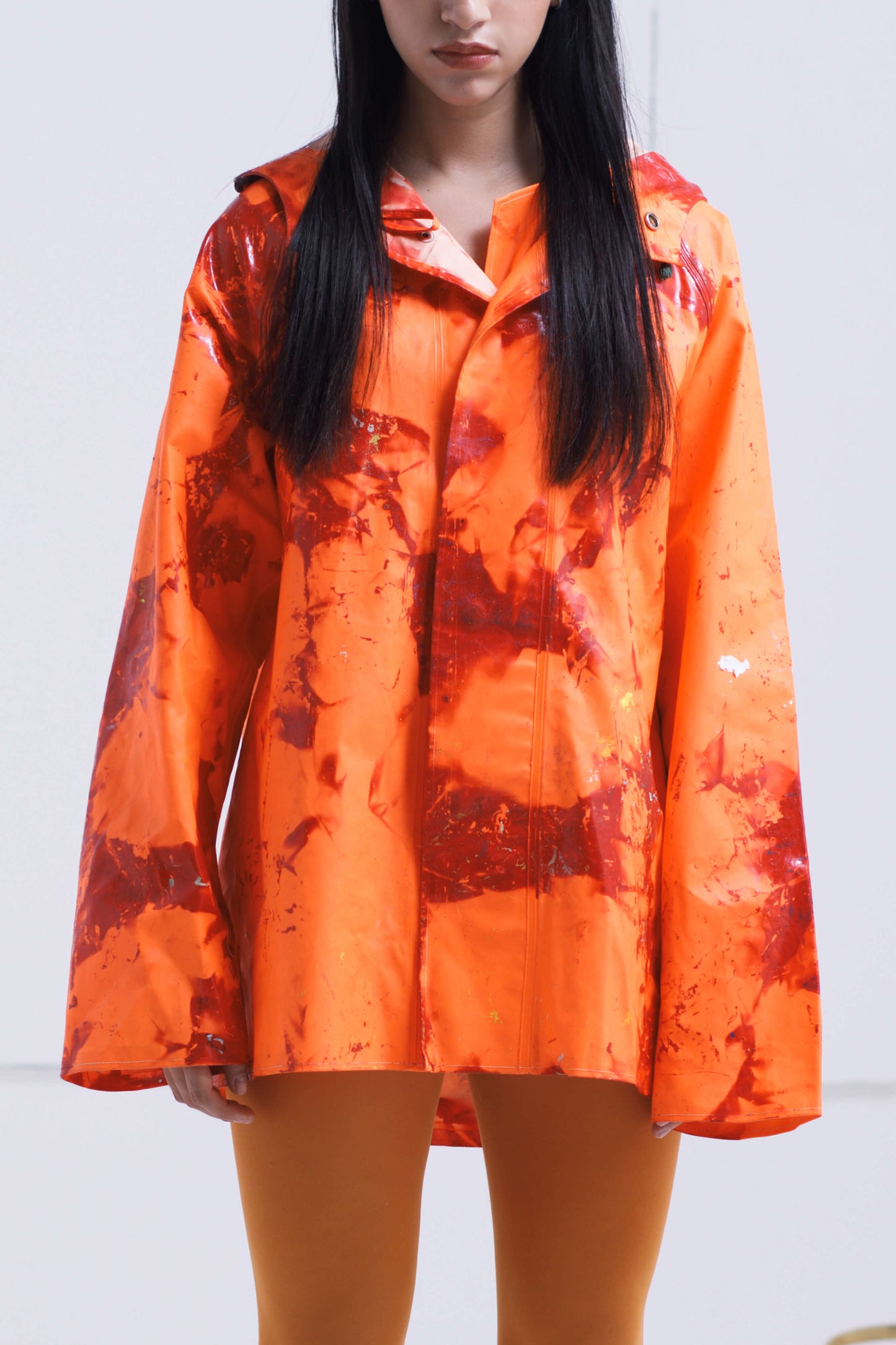 ORANGE RAINCOAT INTERVENED WITH SPRAY PAINT X ALDO CHAPARRO