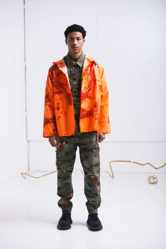 ORANGE RAINCOAT INTERVENED WITH SPRAY PAINT X ALDO CHAPARRO