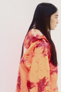 ORANGE RAINCOAT INTERVENED WITH SPRAY PAINT X ALDO CHAPARRO