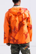 ORANGE RAINCOAT INTERVENED WITH SPRAY PAINT X ALDO CHAPARRO