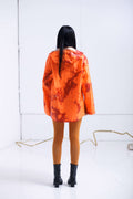 ORANGE RAINCOAT INTERVENED WITH SPRAY PAINT X ALDO CHAPARRO